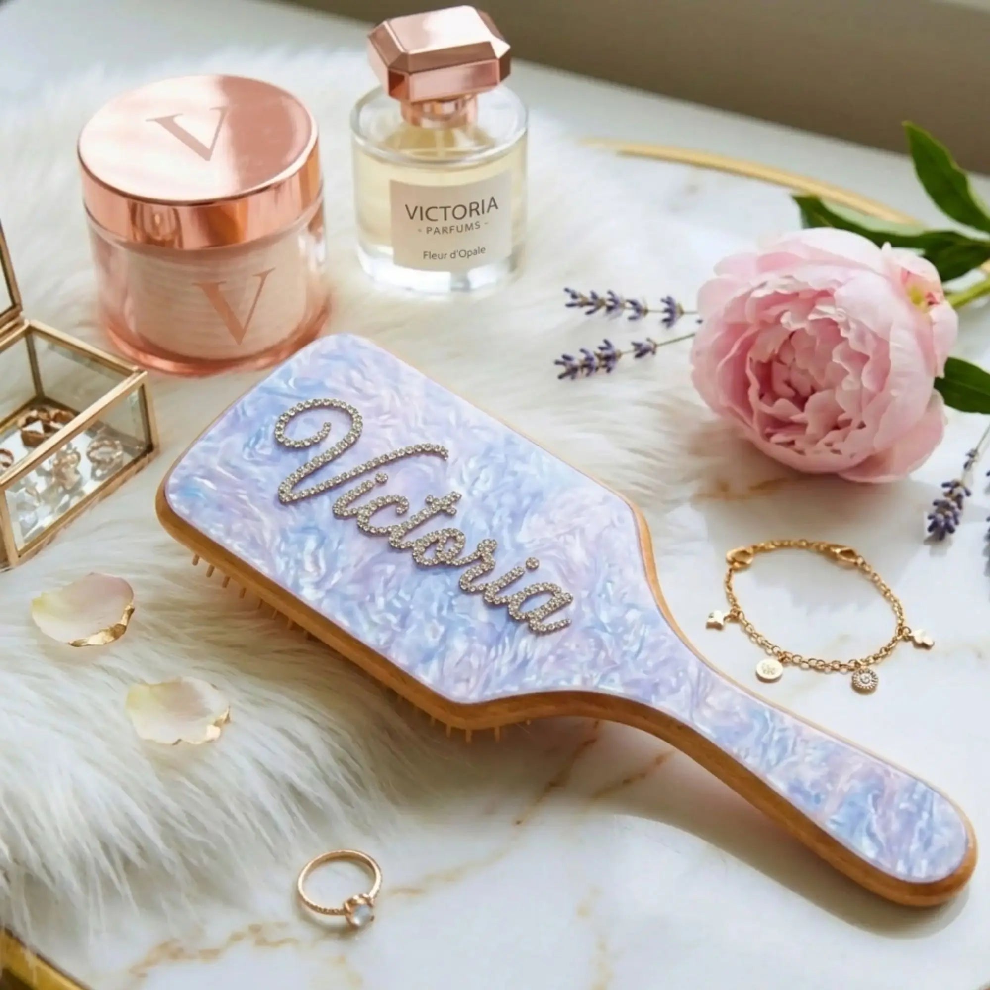 Embellished wooden hair brush with light blue rhinestone pad and rhinestone name