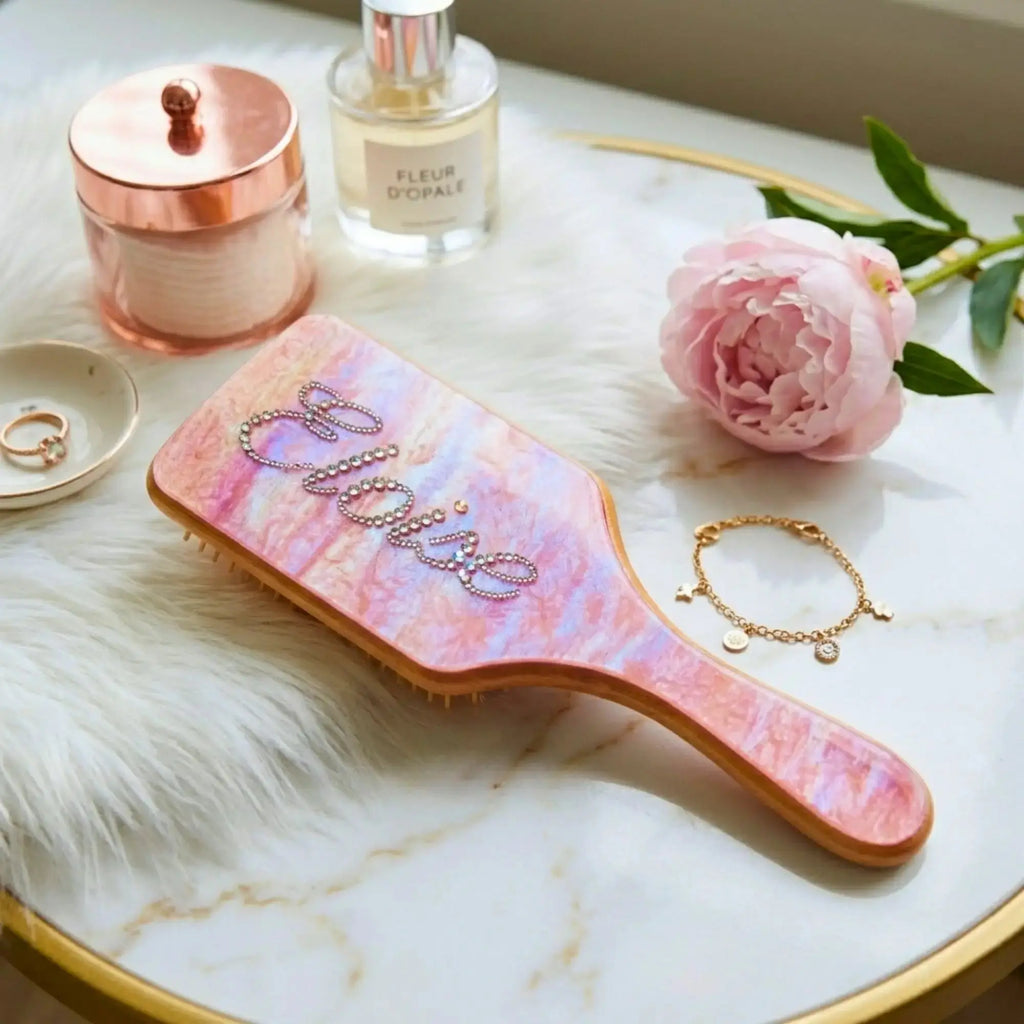 Rhinestone air cushion hair brush with pink marbled cushion and wooden handle