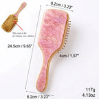 Pink marbled air cushion hair brush with wooden handle and gold bristle teeth