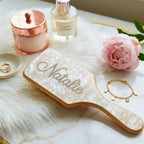 Pearlescent white air-cushion hair brush with silver rhinestone scrolling design