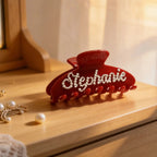 Red rhinestone and pearl hair claw clip with raised letter design, secure grip