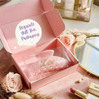 Pink gift box packaging with pearl-adorned hair claws inside.